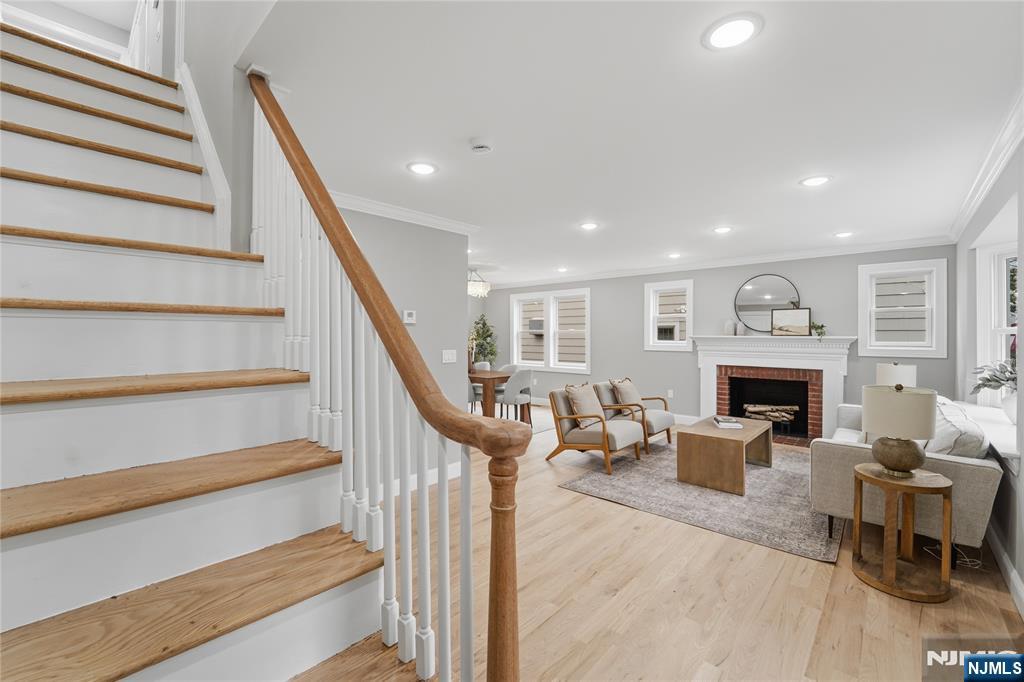 64 Morningside Road Verona, NJ 07044 - Photo 3 of 49 a living room with furniture a fireplace and a floor to ceiling window