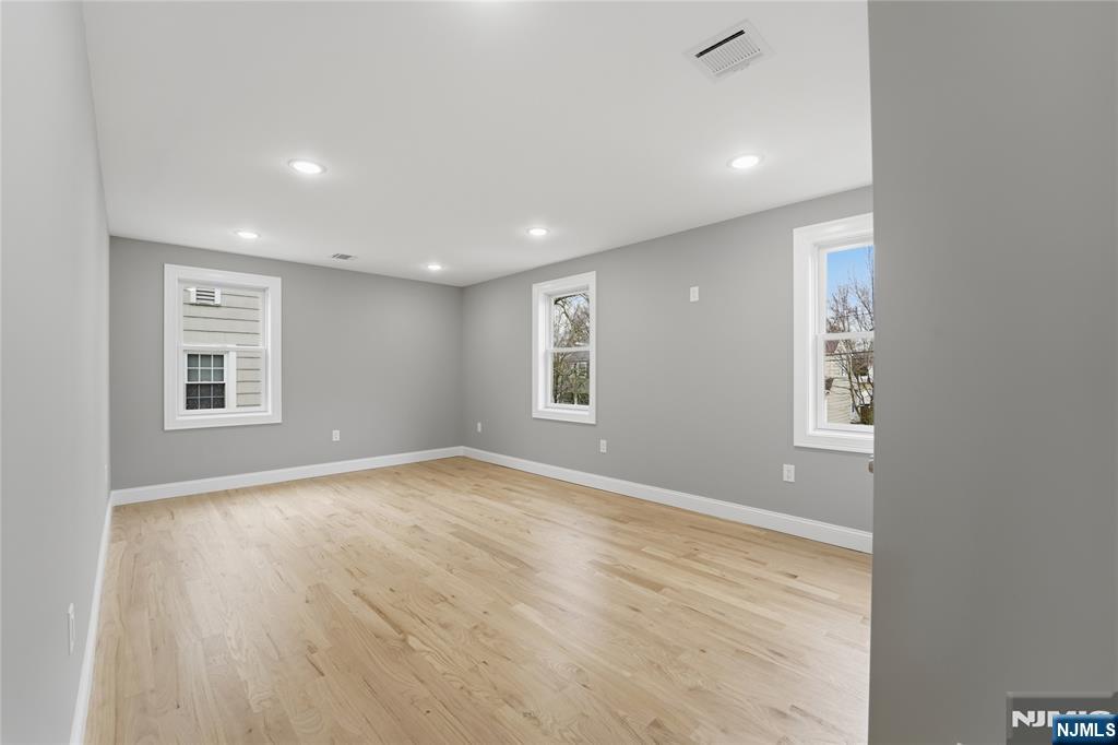 64 Morningside Road Verona, NJ 07044 - Photo 35 of 49 a view of an empty room with wooden floor and a window