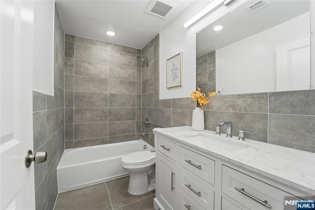 64 Morningside Road Verona, NJ 07044 - Photo 40 of 49 a bathroom with a bathtub shower sink vanity and toilet