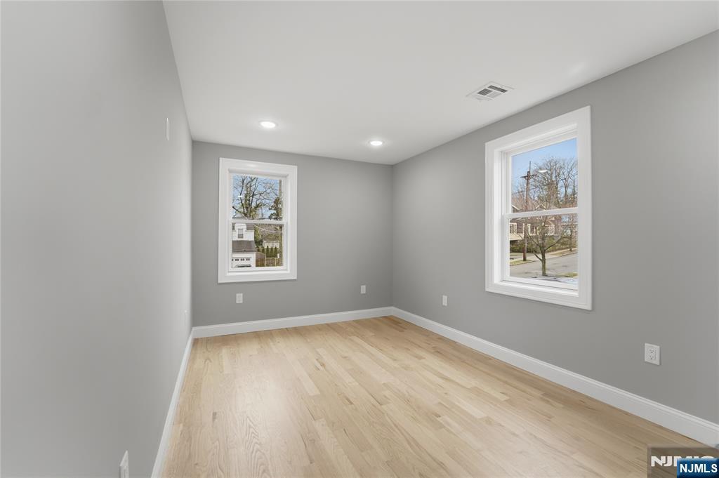 64 Morningside Road Verona, NJ 07044 - Photo 43 of 49 a view of an empty room with a window and wooden floor