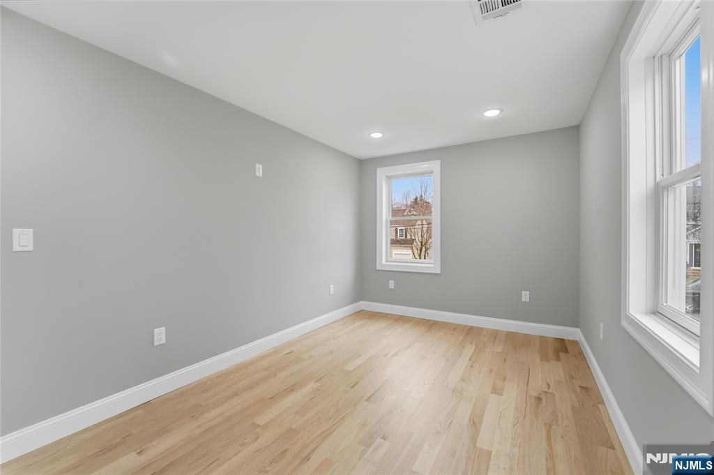 64 Morningside Road Verona, NJ 07044 - Photo 44 of 49 an empty room with wooden floor and windows