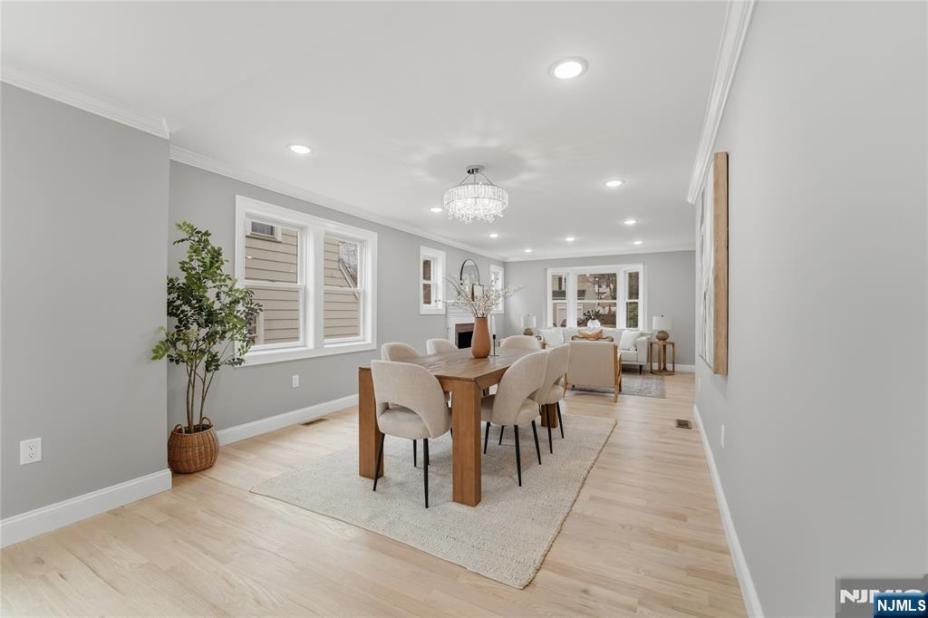 64 Morningside Road Verona, NJ 07044 - Photo 9 of 49 a dining room with furniture potted plants and wooden floor