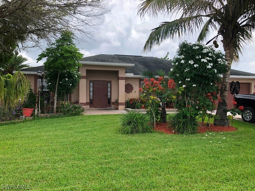 a front view of house with yard and outdoor seating
