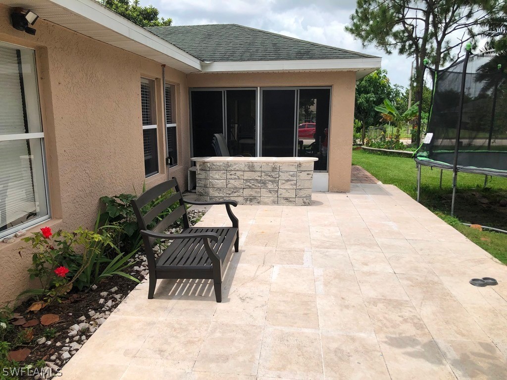 203 Roat Street Lehigh Acres, FL 33936 - Photo 6 of 15 a view of a house with backyard and sitting area