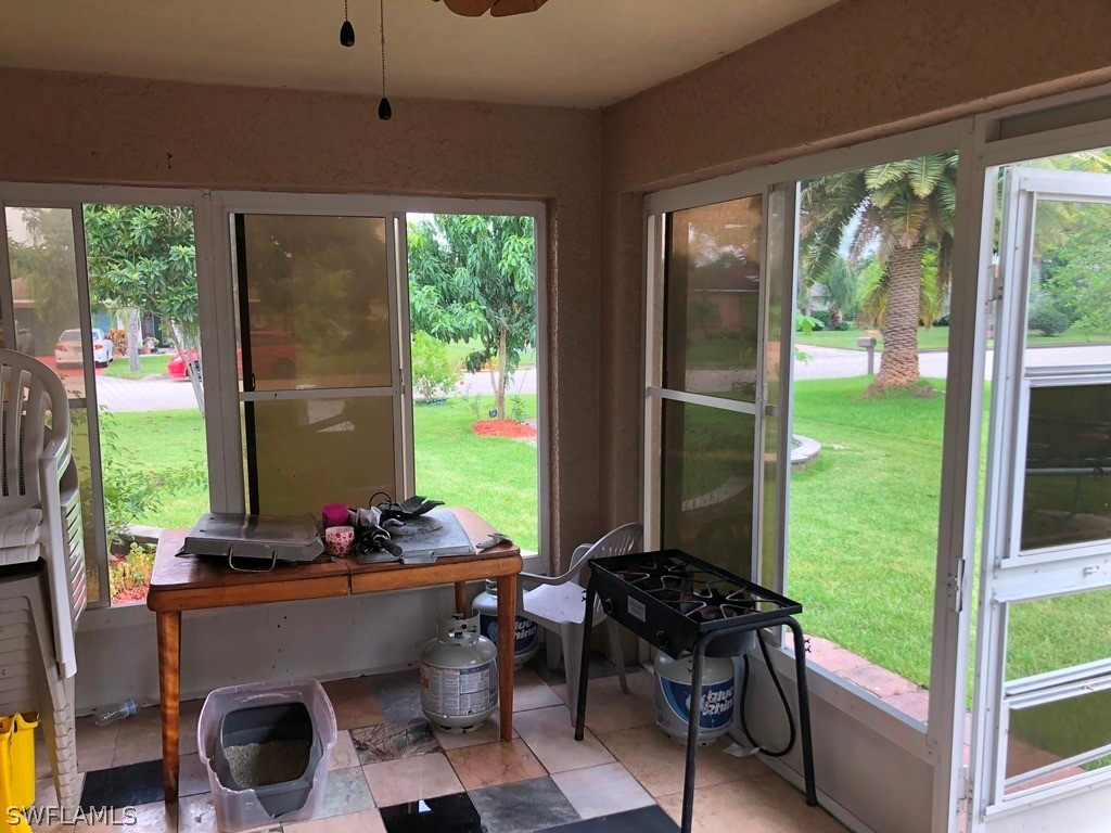 203 Roat Street Lehigh Acres, FL 33936 - Photo 7 of 15 a room with furniture and a large window