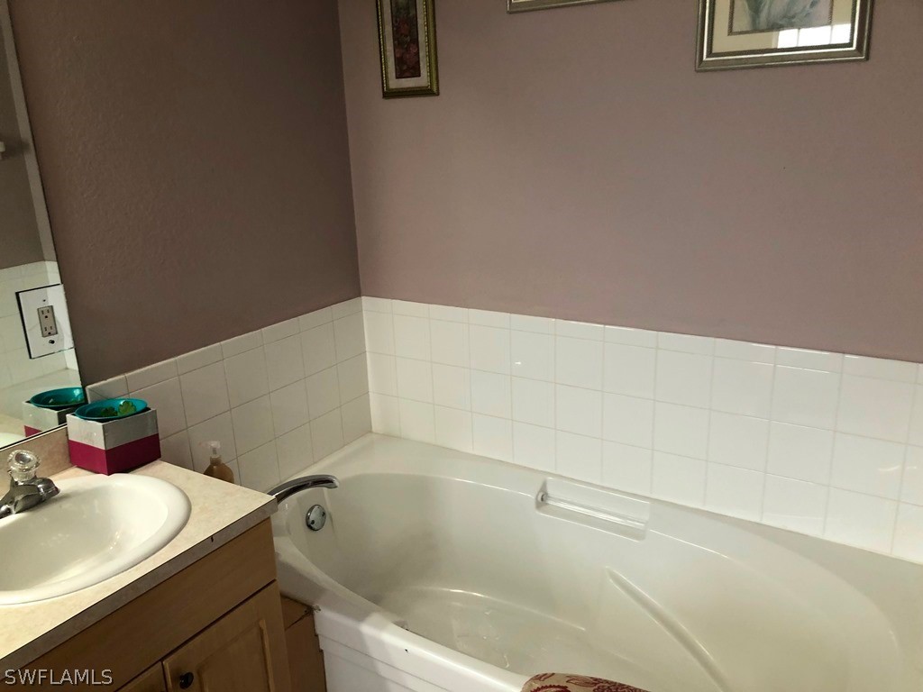 203 Roat Street Lehigh Acres, FL 33936 - Photo 10 of 15 a bathroom with a sink and a bathtub