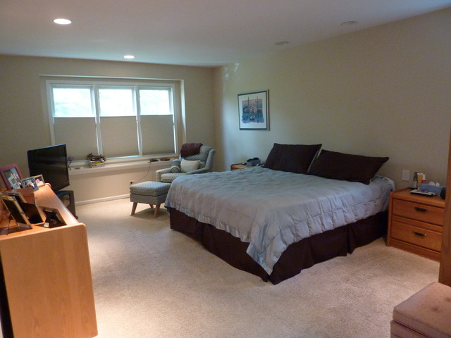 631 Raintree Road Buffalo Grove, IL 60089 - Photo 12 of 22 a bedroom with a bed a couch and a dresser with wooden floor