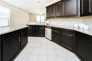 a kitchen with stainless steel appliances granite countertop a sink counter space cabinets and a large window