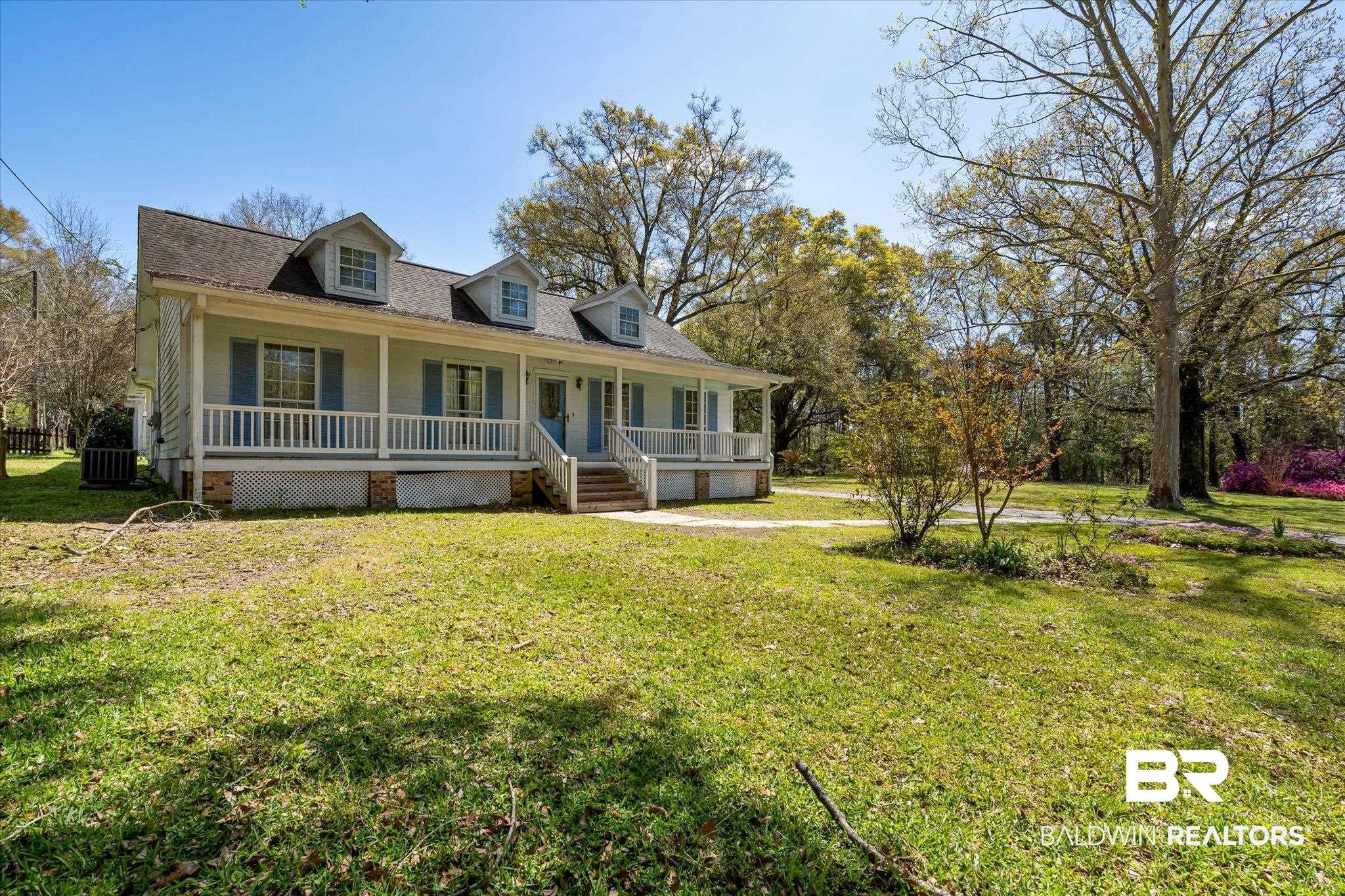 6030 Lott Road Eight Mile, AL 36613 - Photo 20 of 21 New england style home with covered porch, central air condition unit, and a front yard