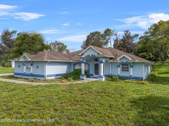 13377 Elise Lane Spring Hill, FL 34609 - Photo 1 of 30 a front view of a house with a yard