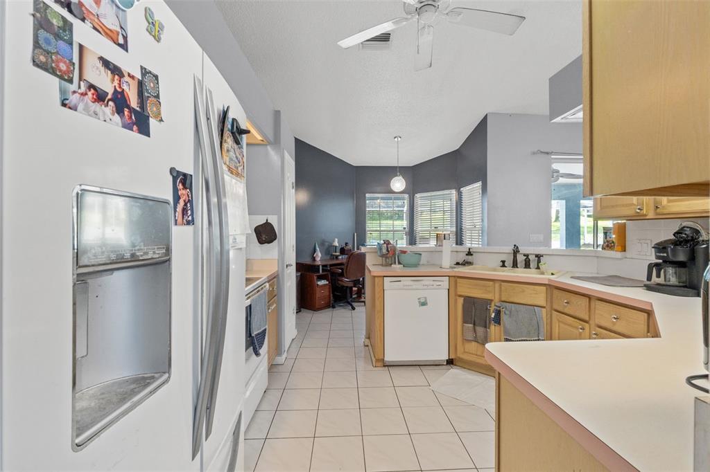 13377 Elise Lane Spring Hill, FL 34609 - Photo 11 of 30 a kitchen with a refrigerator a sink and dishwasher
