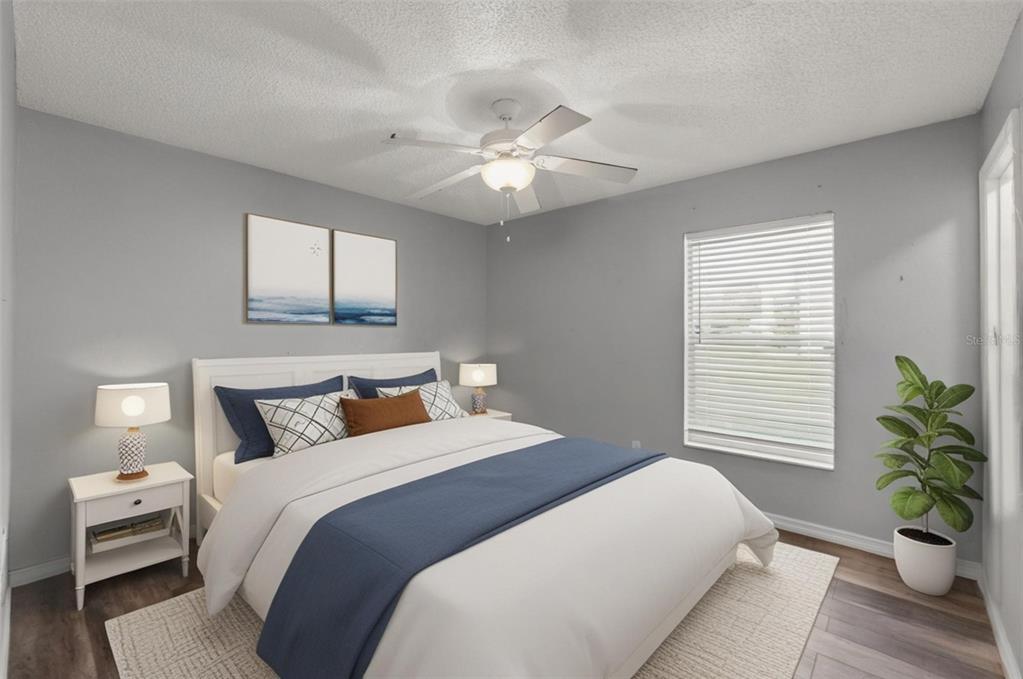 13377 Elise Lane Spring Hill, FL 34609 - Photo 14 of 30 a bedroom with a bed and a potted plant