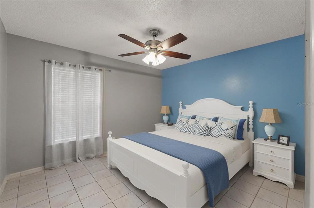 13377 Elise Lane Spring Hill, FL 34609 - Photo 17 of 30 a bedroom with a bed and a chandelier