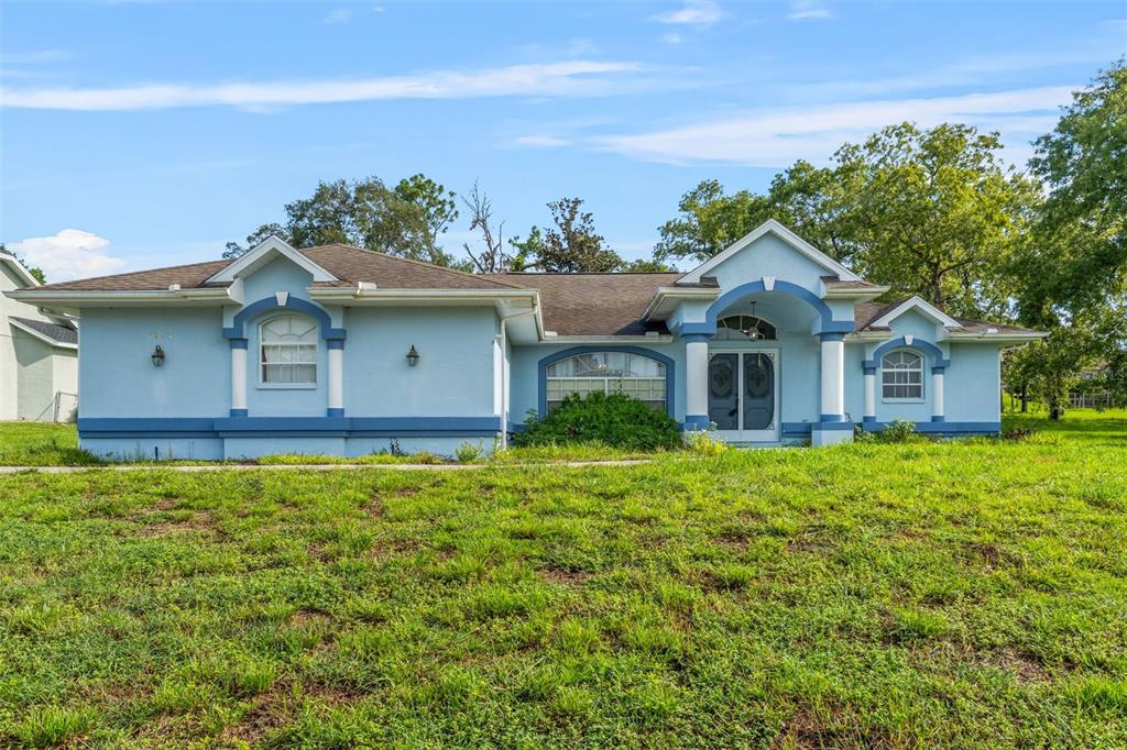13377 Elise Lane Spring Hill, FL 34609 - Photo 2 of 30 a front view of a house with a yard