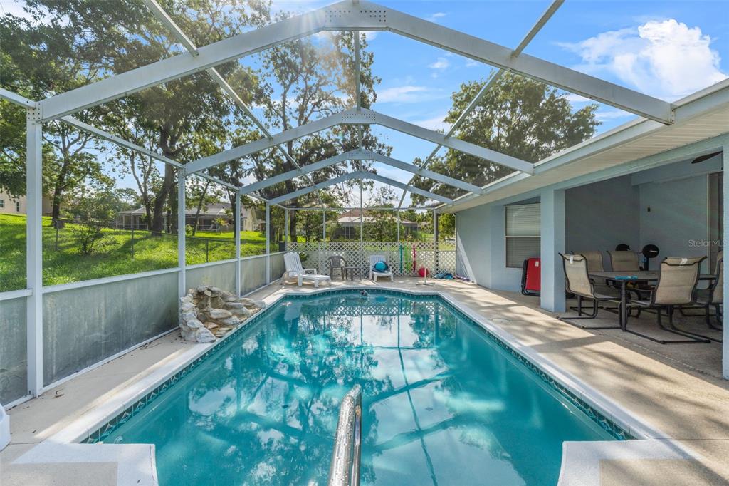 13377 Elise Lane Spring Hill, FL 34609 - Photo 21 of 30 a view of swimming pool with a couches and chairs