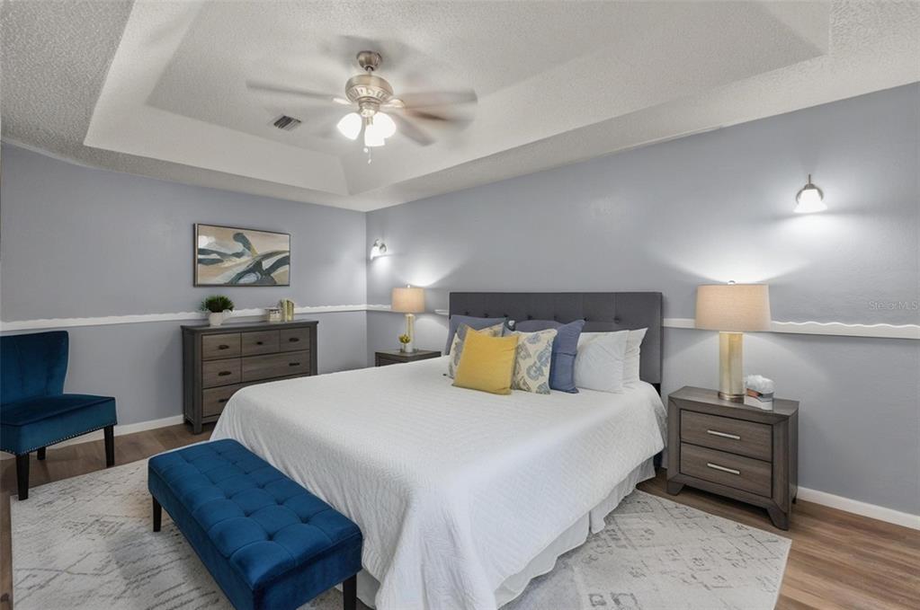 13377 Elise Lane Spring Hill, FL 34609 - Photo 7 of 30 a bedroom with a bed and a chandelier