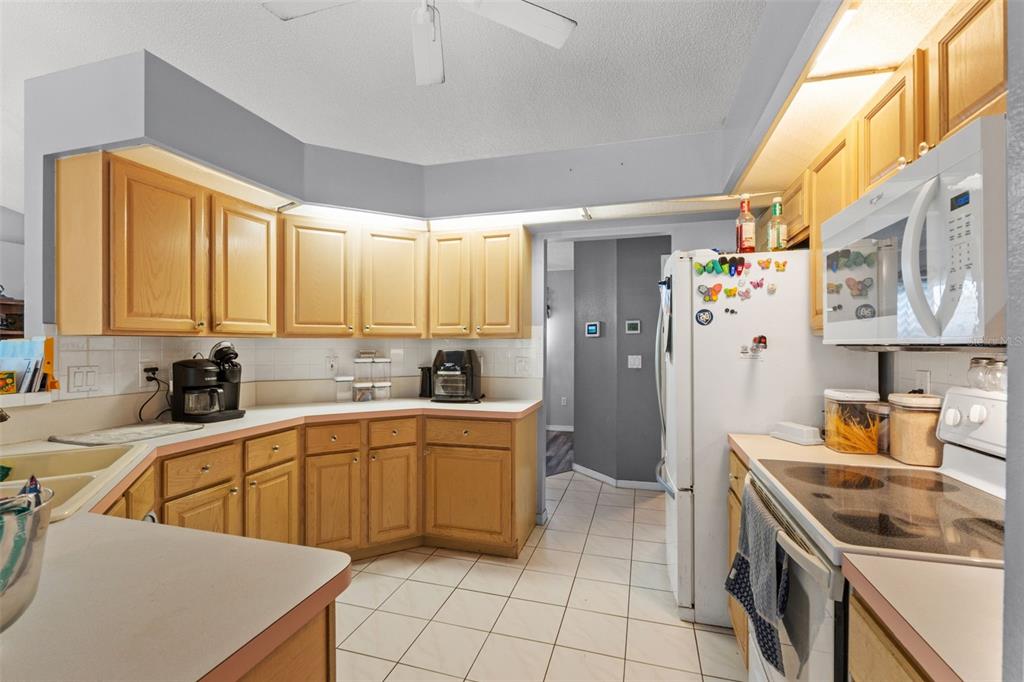 13377 Elise Lane Spring Hill, FL 34609 - Photo 9 of 30 a kitchen that has a sink and a stove top oven