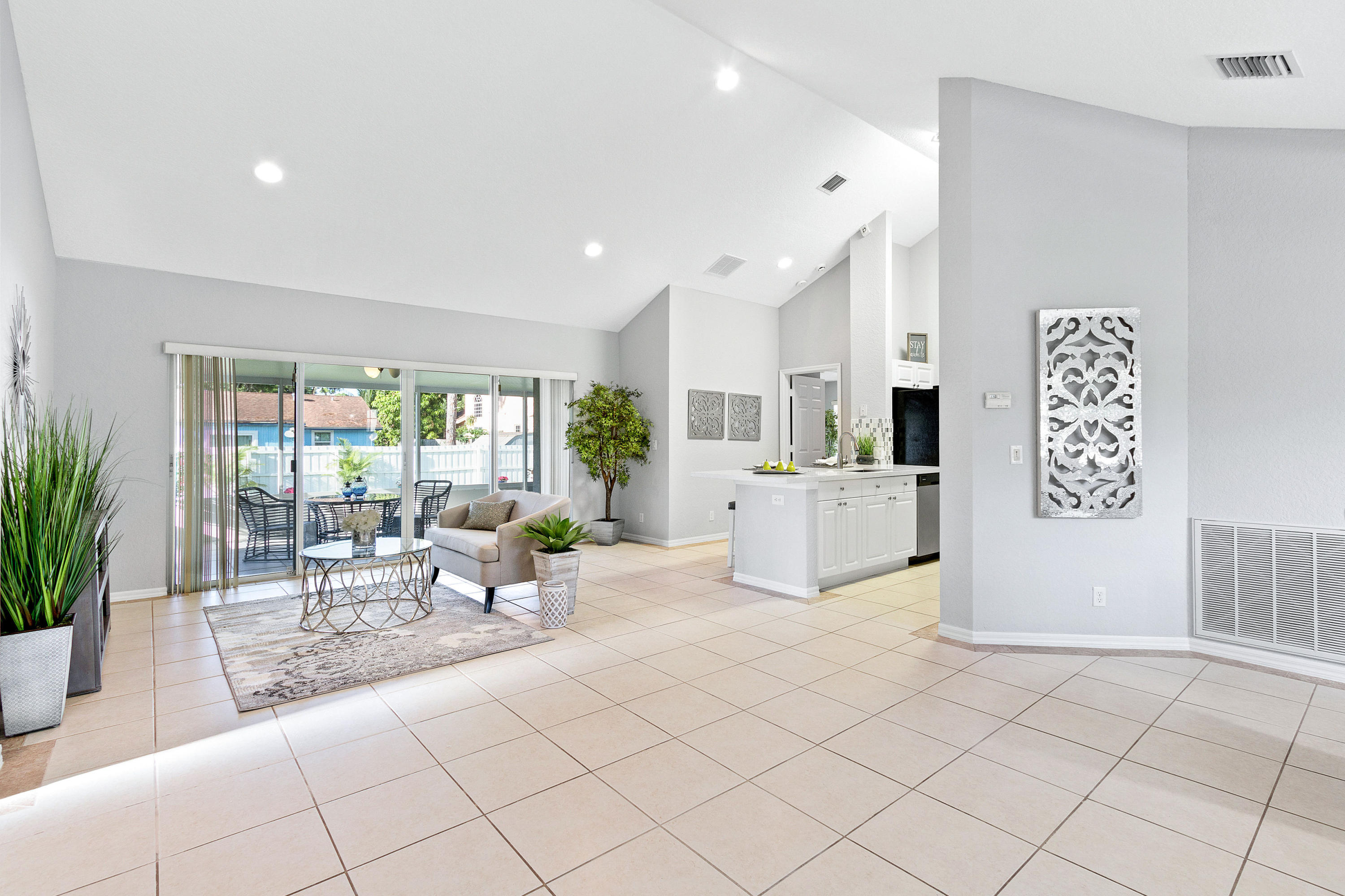 5317 Palm Ridge Boulevard Delray Beach, FL 33484 - Photo 11 of 39 a living room with kitchen island furniture and a potted plant