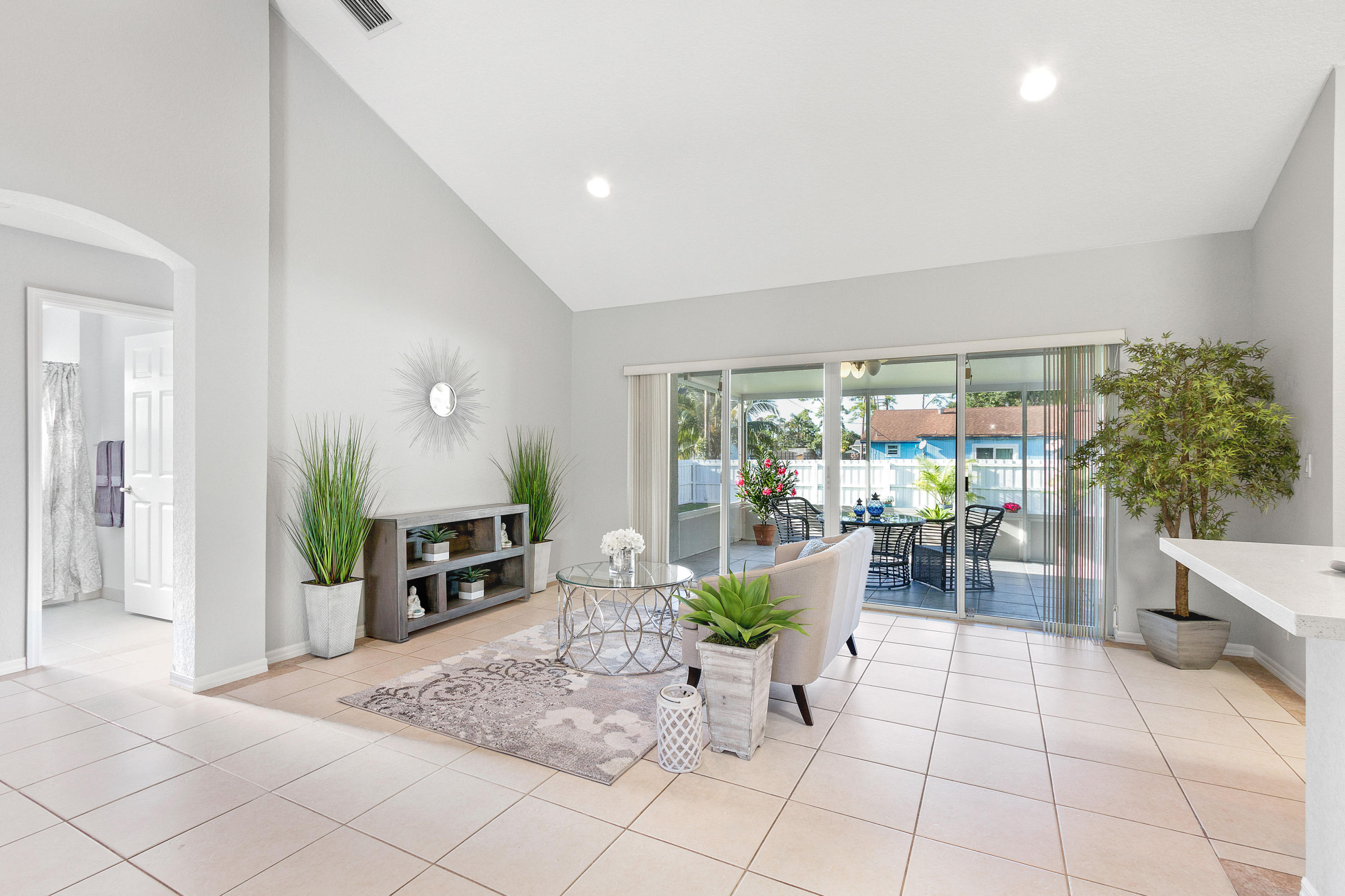 5317 Palm Ridge Boulevard Delray Beach, FL 33484 - Photo 13 of 39 a living room with furniture a potted plant and a large window