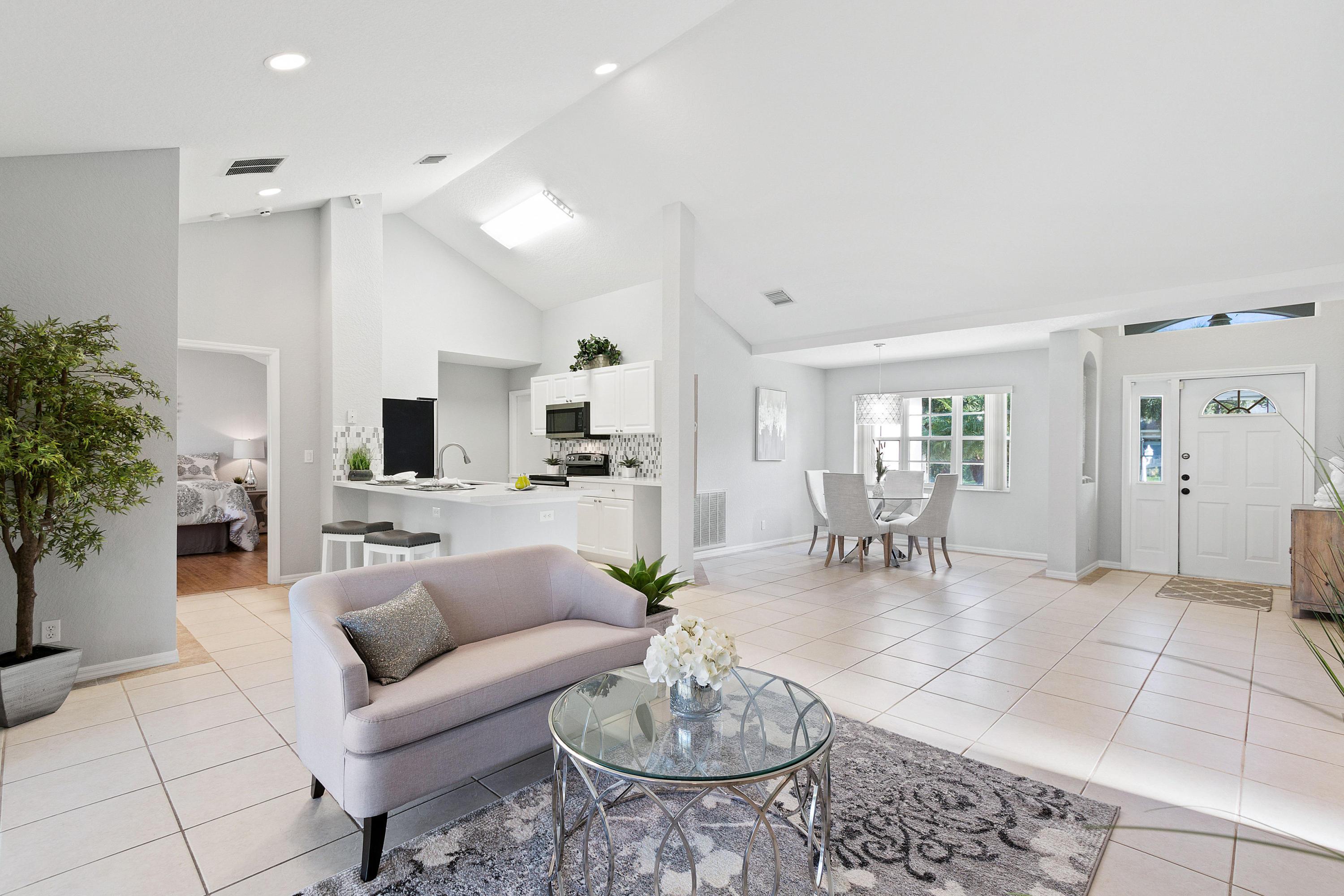 5317 Palm Ridge Boulevard Delray Beach, FL 33484 - Photo 14 of 39 a living room with furniture and a dining table with kitchen view