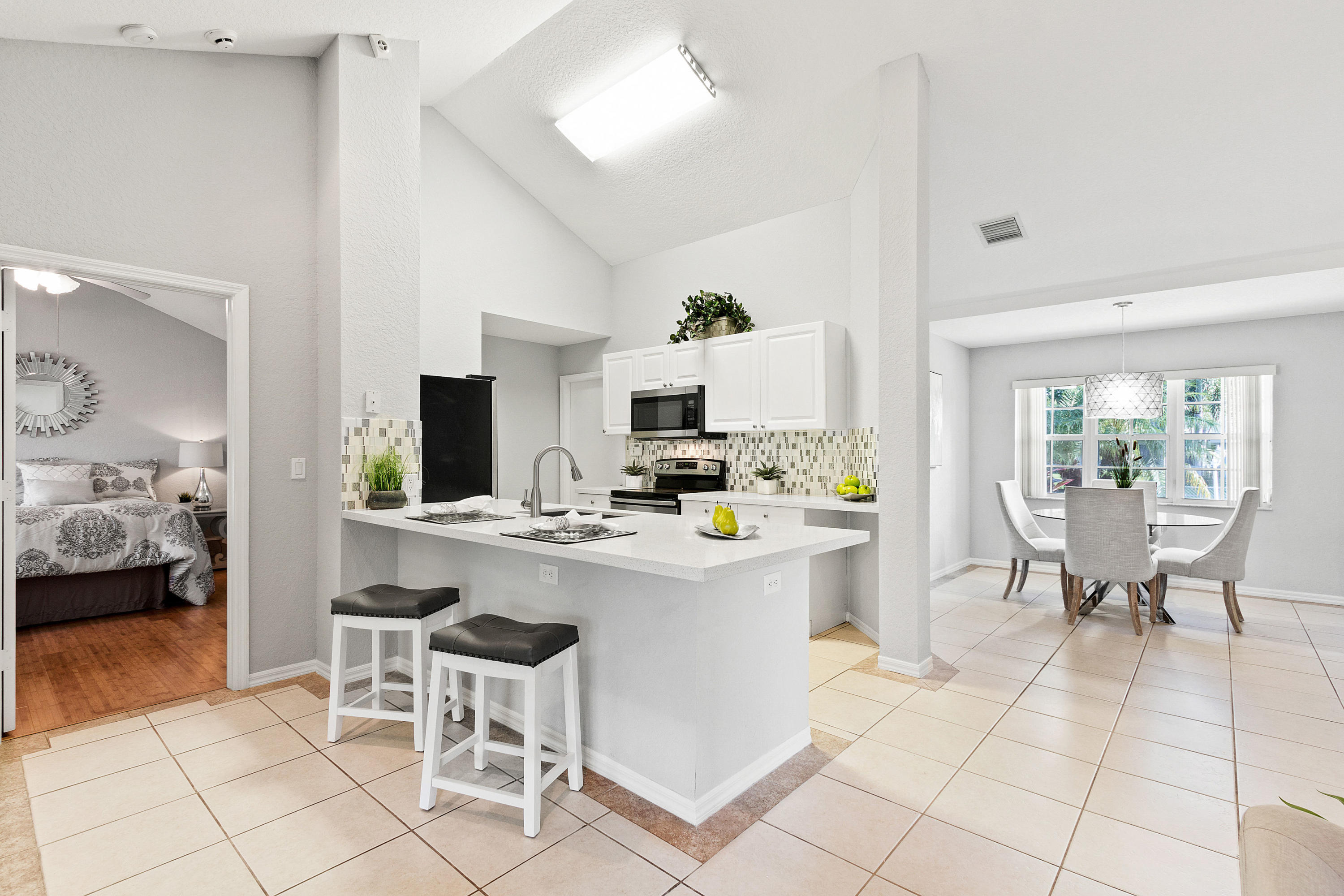 5317 Palm Ridge Boulevard Delray Beach, FL 33484 - Photo 15 of 39 a view of kitchen with stainless steel appliances kitchen island dining table and chairs