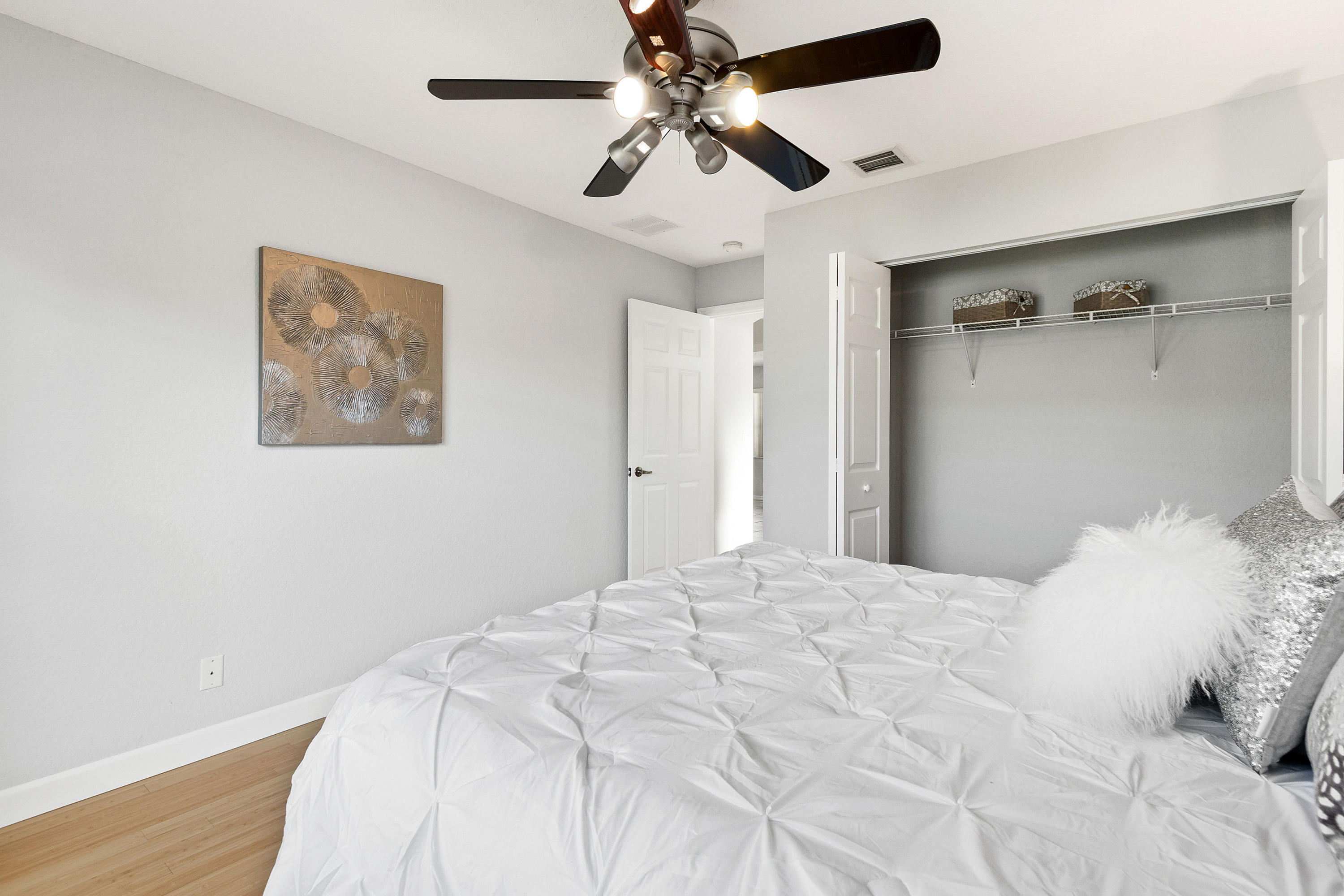 5317 Palm Ridge Boulevard Delray Beach, FL 33484 - Photo 28 of 39 a bedroom with a large bed and a chandelier