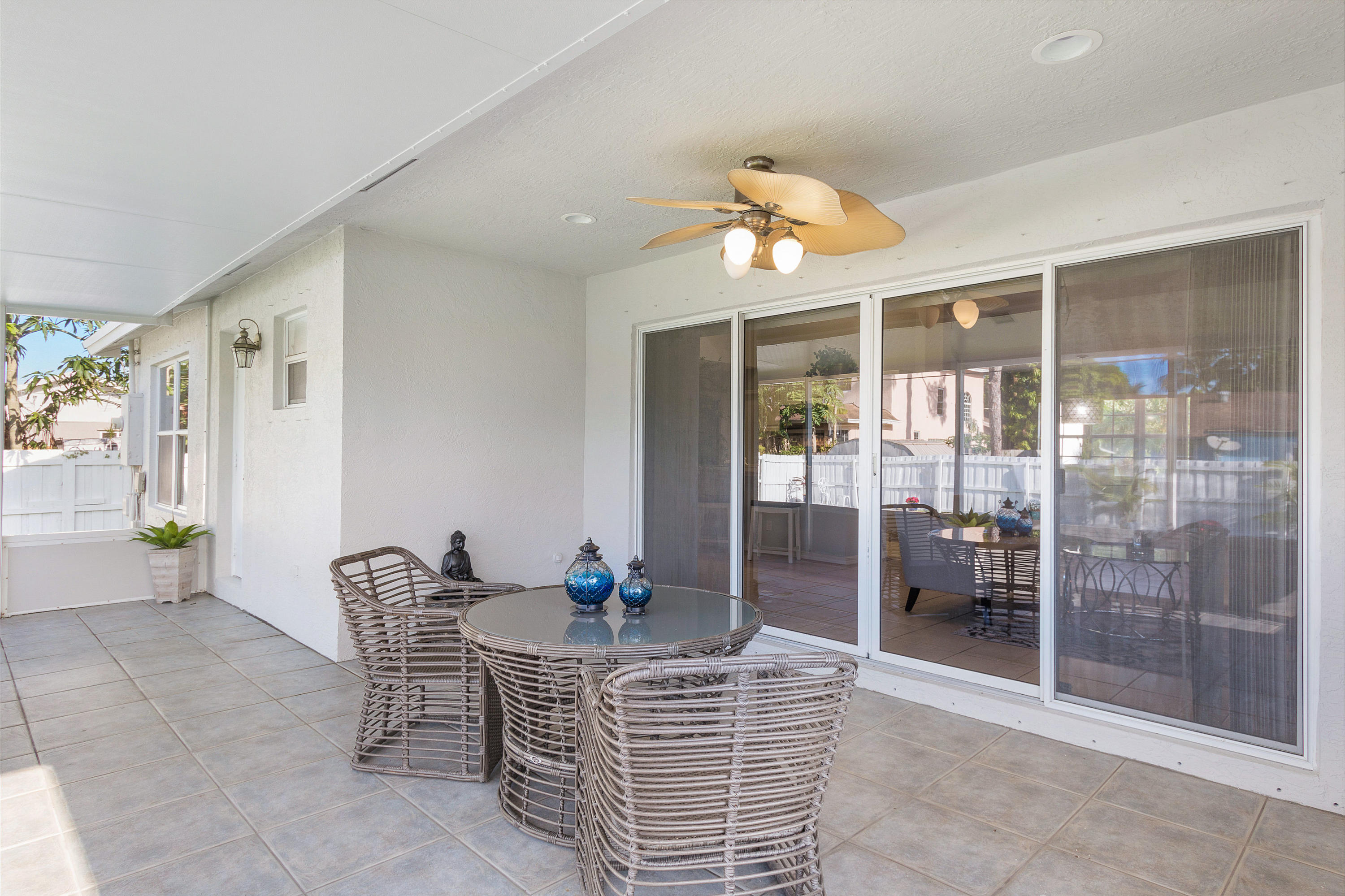 5317 Palm Ridge Boulevard Delray Beach, FL 33484 - Photo 34 of 39 a dining room with furniture a chandelier and window
