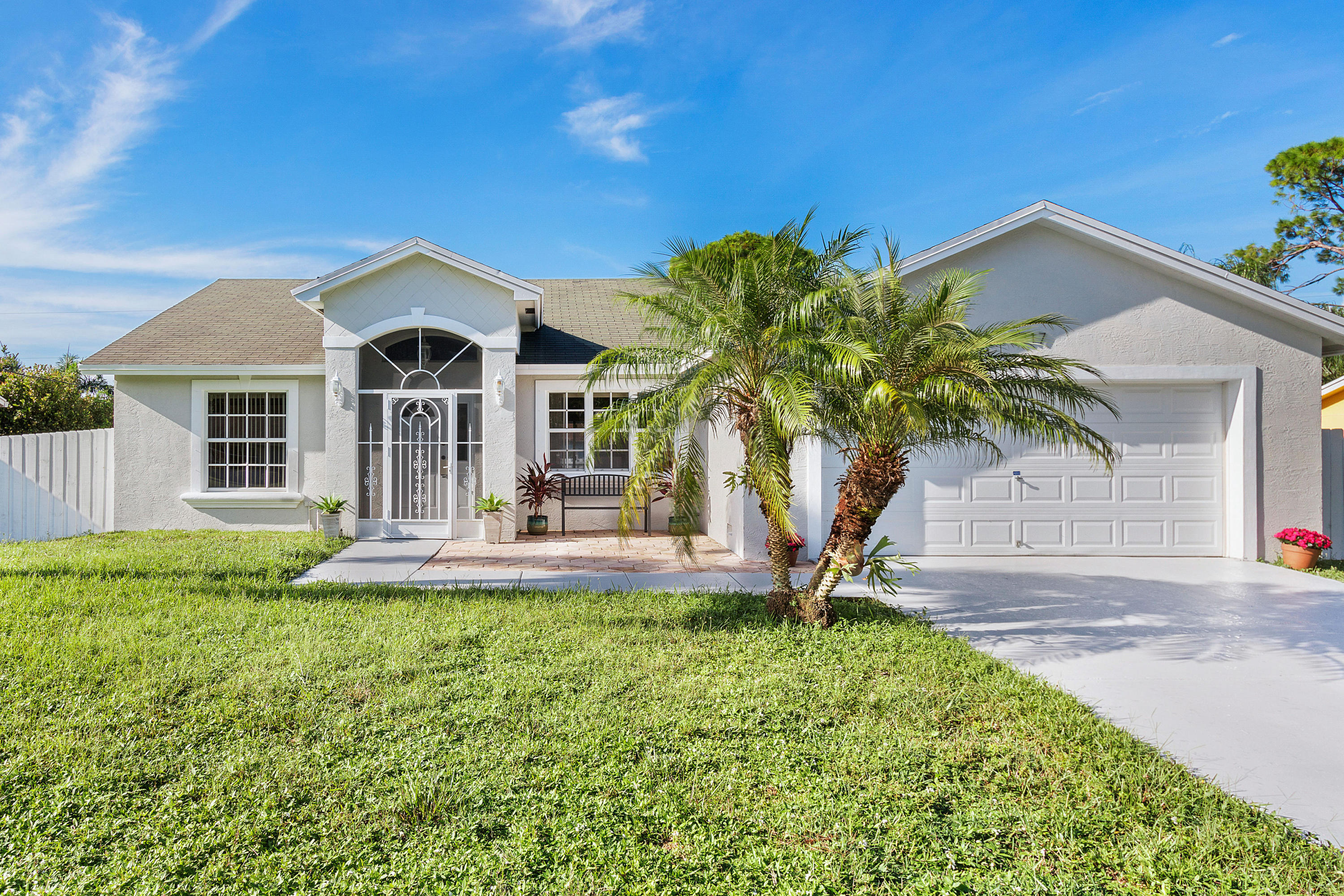 5317 Palm Ridge Boulevard Delray Beach, FL 33484 - Photo 5 of 39 a front view of a house with a yard