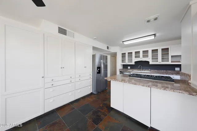 a kitchen with stainless steel appliances granite countertop a stove and a refrigerator