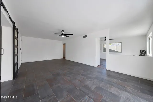a view of a big room with closet and windows