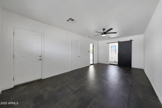 a view of an empty room with a ceiling fan