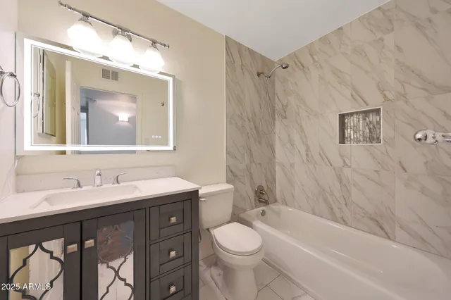 a bathroom with a sink a toilet and a bathtub