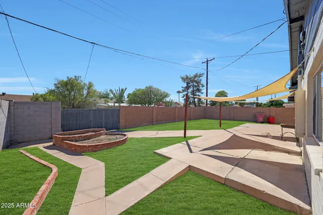 a view of a backyard with sitting area