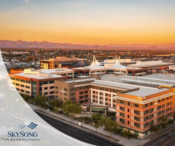 an aerial view of residential building with parking and ocean view