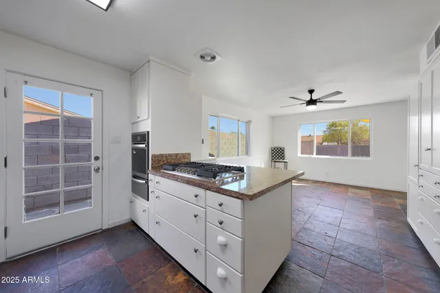 a kitchen with stainless steel appliances granite countertop a stove and a sink