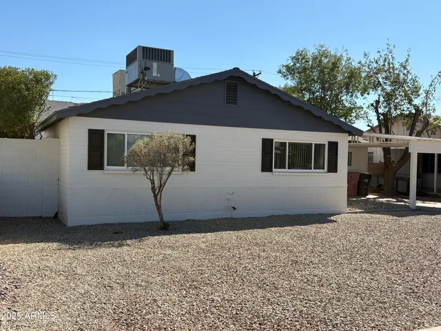 a house that has a tree in front of it