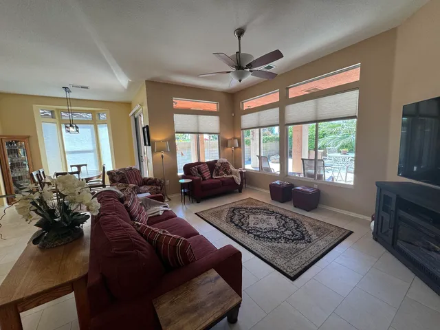 a living room with furniture windows and a flat screen tv