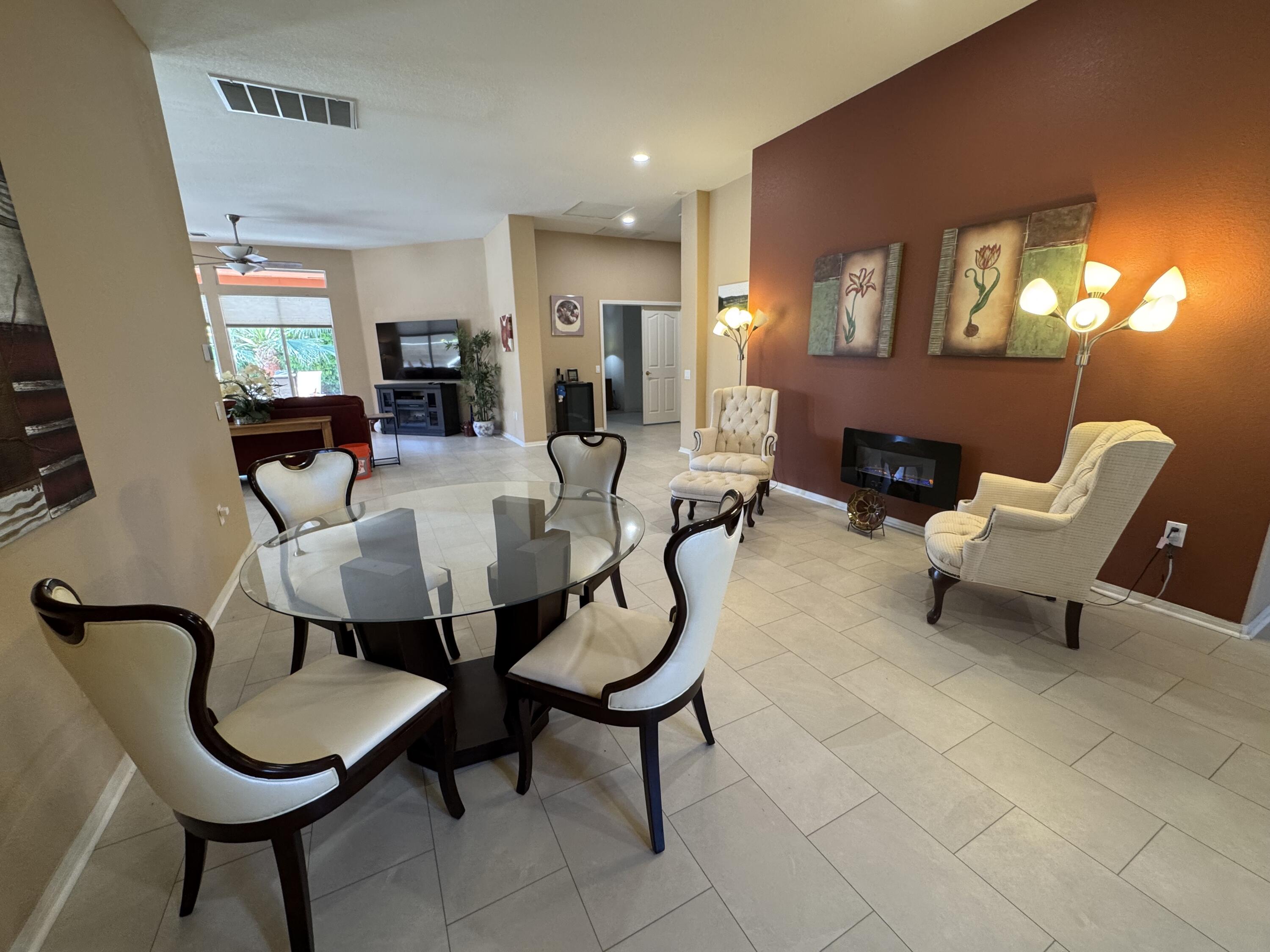 44414 Royal Lytham Drive Indio, CA 92201 - Photo 13 of 47 a living room with furniture a dining table and a fireplace