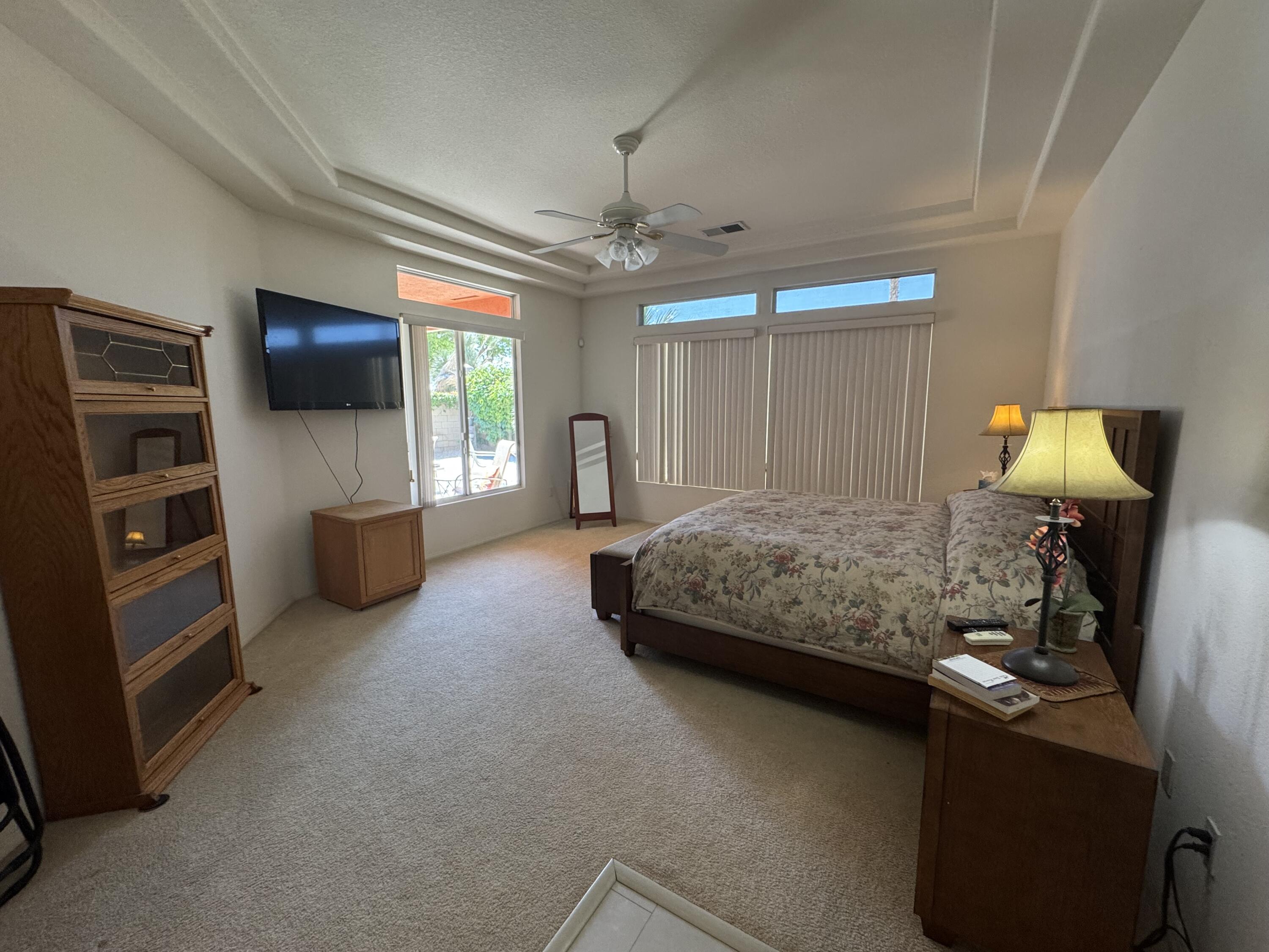 44414 Royal Lytham Drive Indio, CA 92201 - Photo 16 of 47 a bedroom with furniture and a flat screen tv