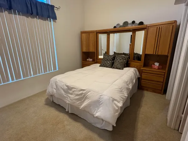 a bed sitting in a bedroom next to a window