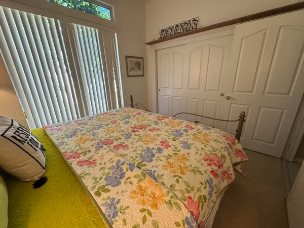 a bed sitting in a bedroom next to a wooden floor