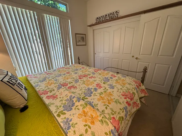 a bed sitting in a bedroom next to a wooden floor