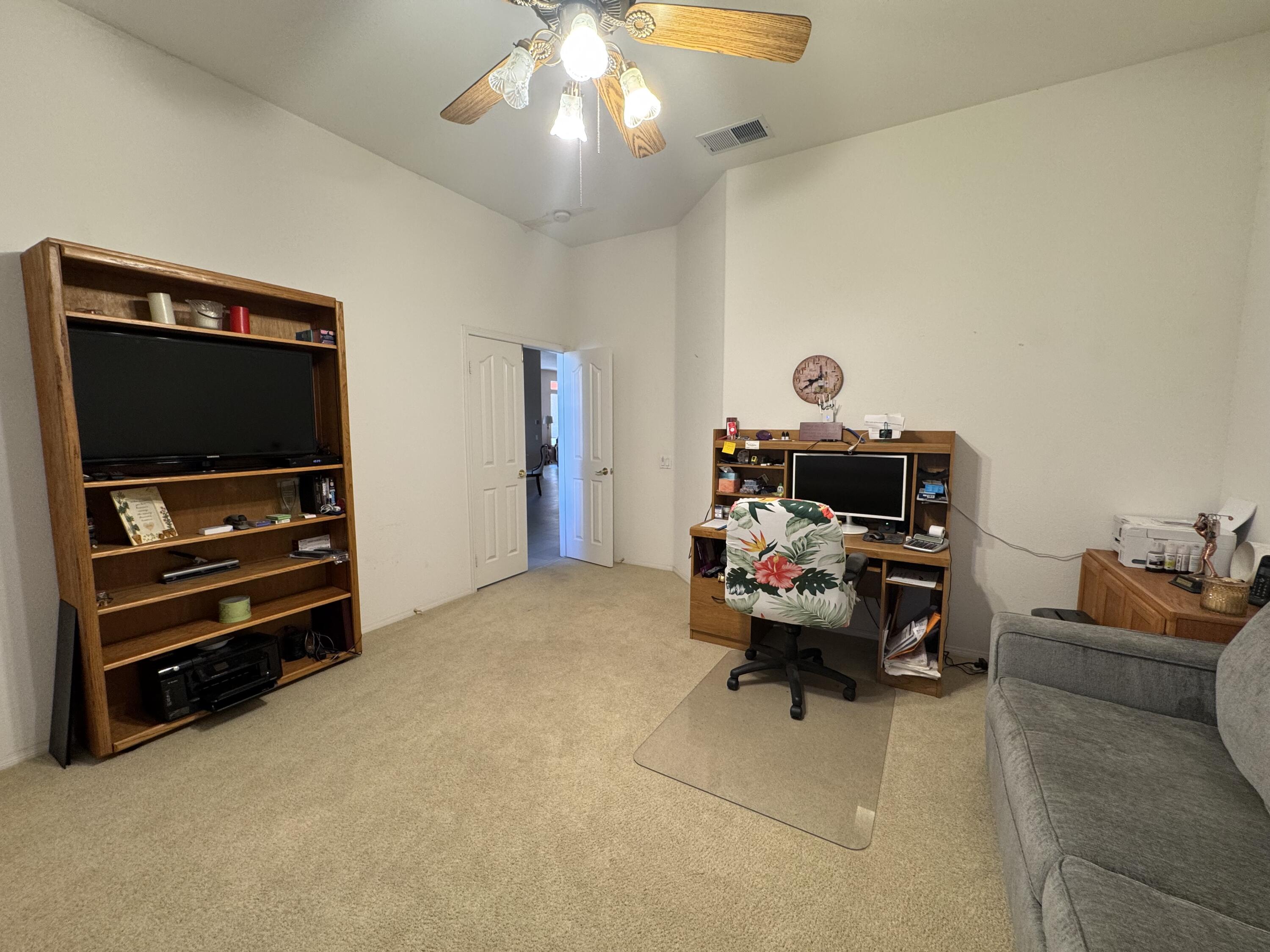 44414 Royal Lytham Drive Indio, CA 92201 - Photo 25 of 47 a living room with furniture and a flat screen tv