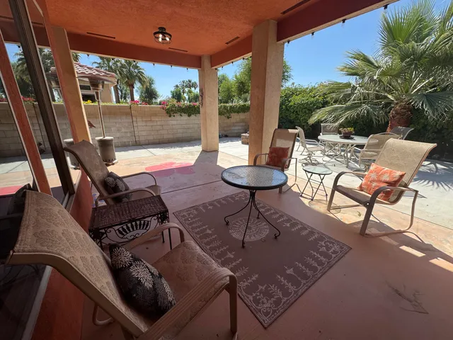 a view of a dinning table and chairs in patio