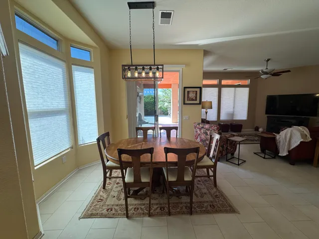 a view of a dining room with furniture window and outside view