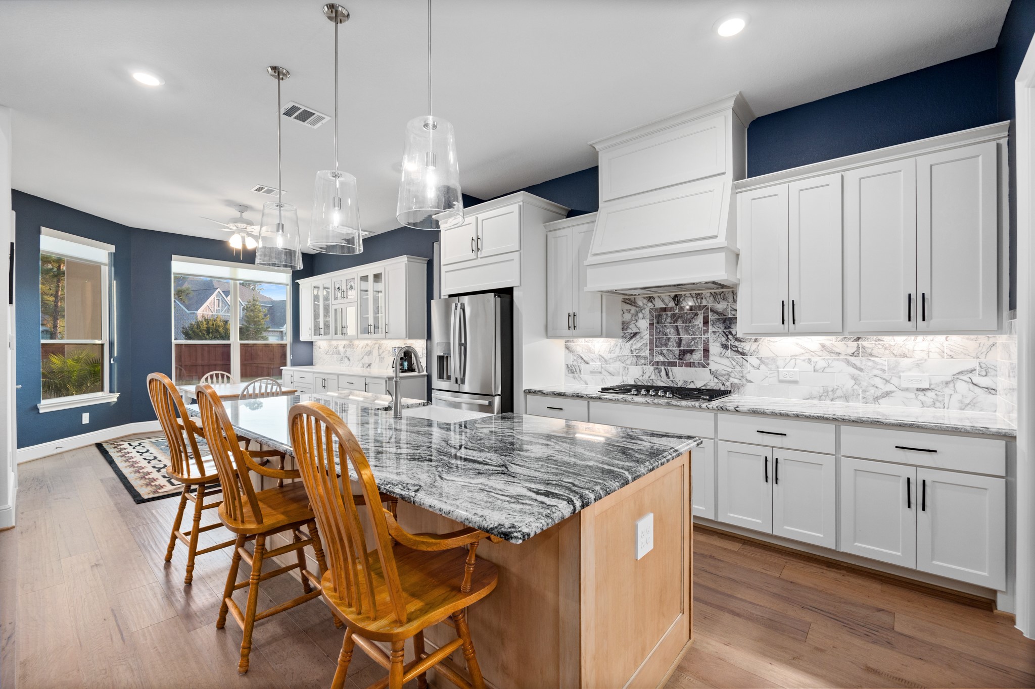 8538 Tynan Ridge Drive Magnolia, TX 77354 - Photo 31 of 50 a kitchen with stainless steel appliances granite countertop a kitchen island hardwood floor and a sink