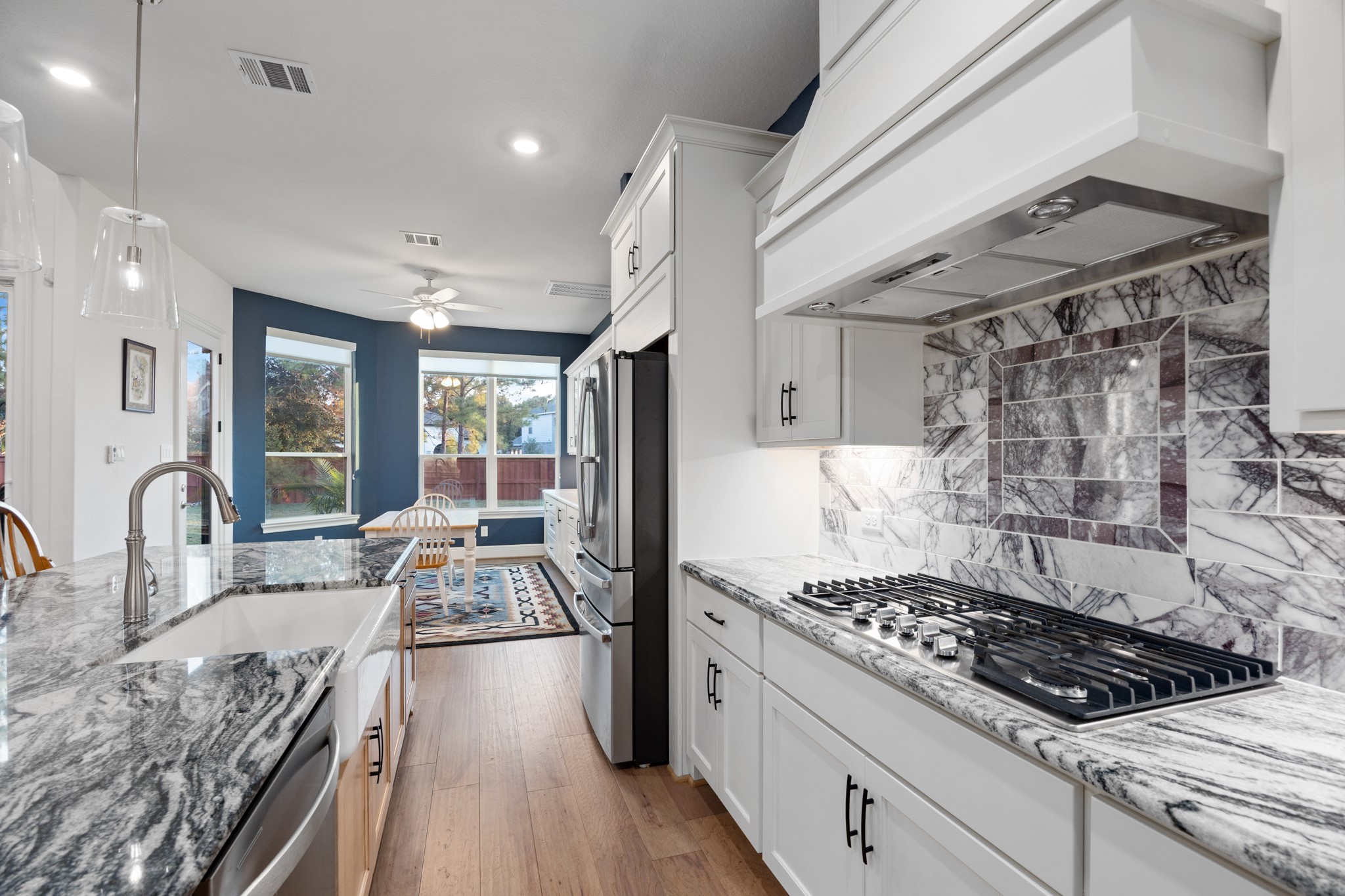 8538 Tynan Ridge Drive Magnolia, TX 77354 - Photo 32 of 50 a kitchen with refrigerator stove and wooden floor