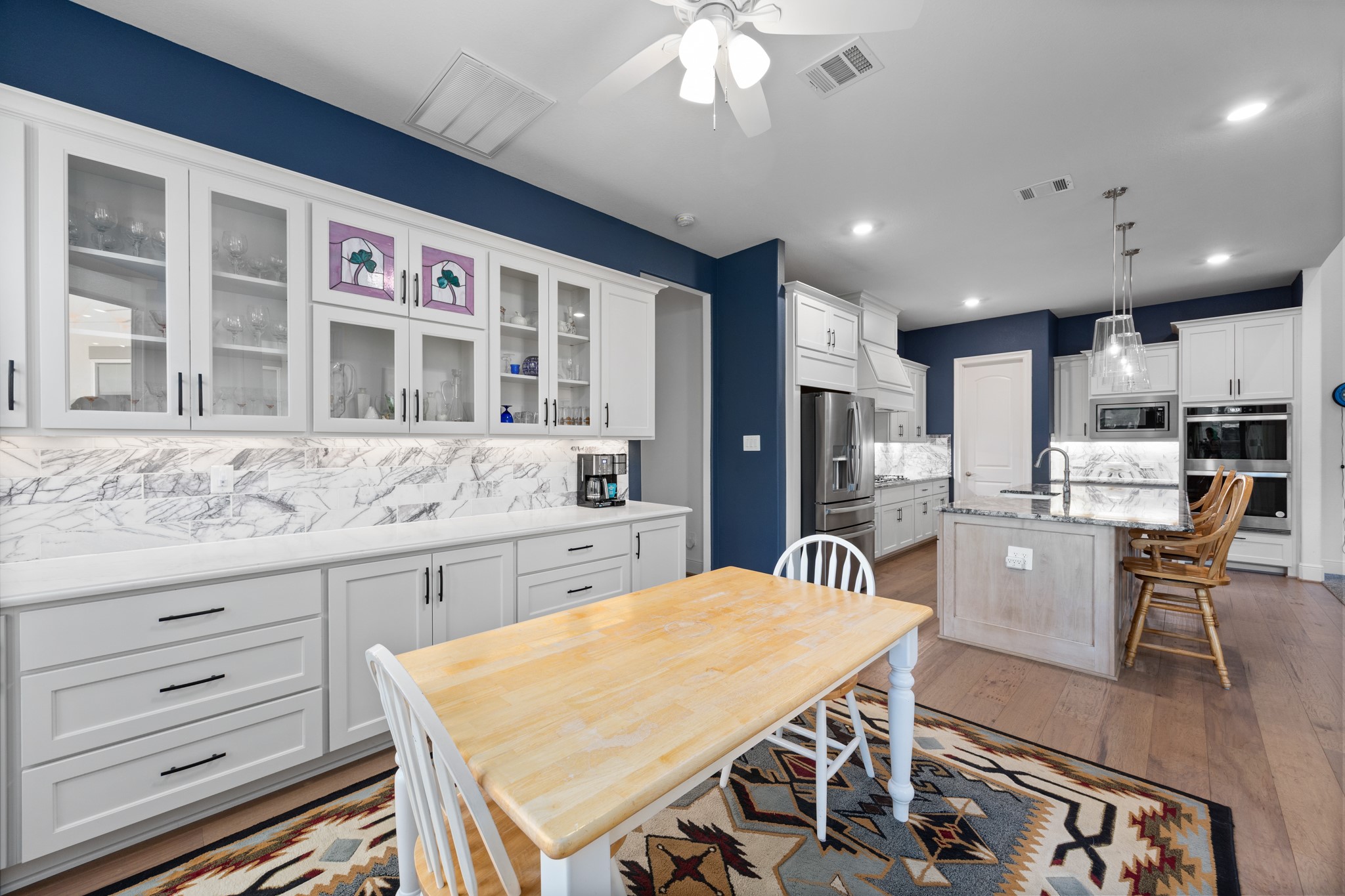 8538 Tynan Ridge Drive Magnolia, TX 77354 - Photo 34 of 50 a kitchen with granite countertop kitchen island stainless steel appliances a sink and counter space