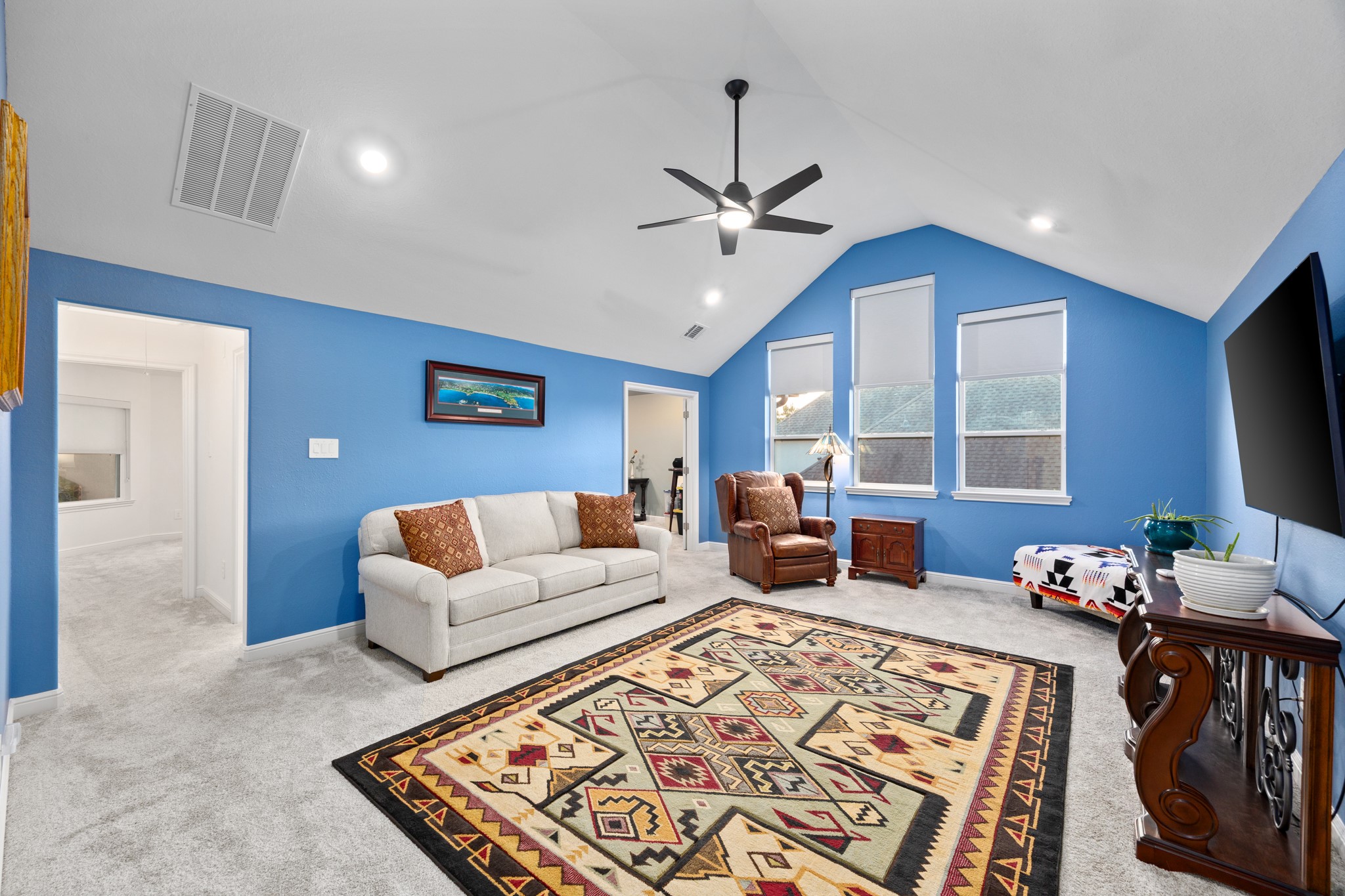 8538 Tynan Ridge Drive Magnolia, TX 77354 - Photo 45 of 50 a living room with furniture ceiling fan and a rug