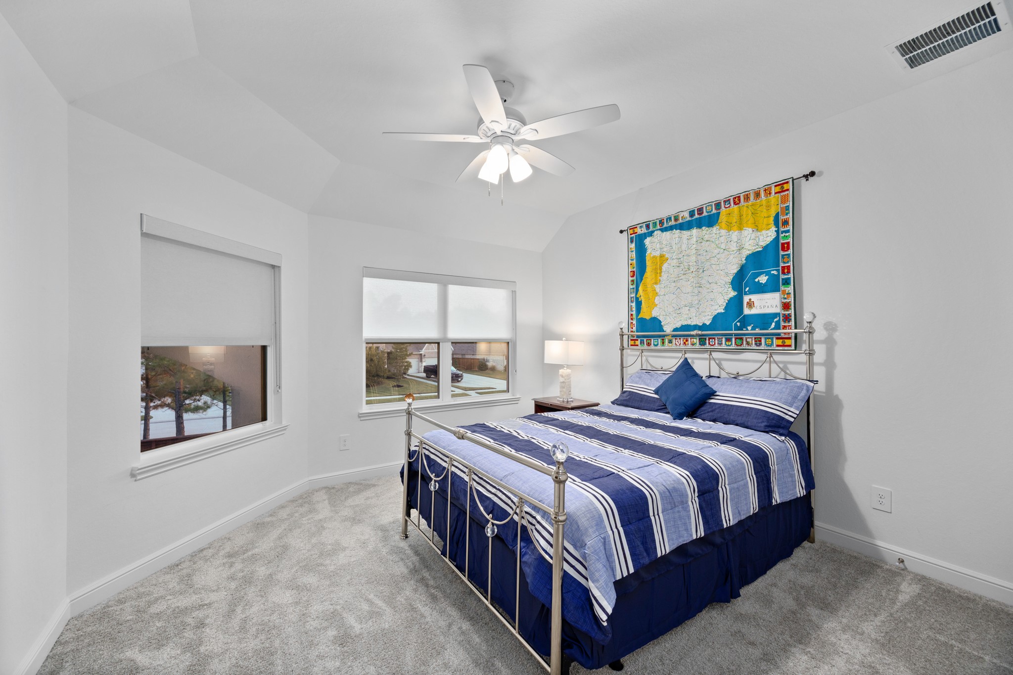 8538 Tynan Ridge Drive Magnolia, TX 77354 - Photo 49 of 50 a bedroom with a bed and a chandelier